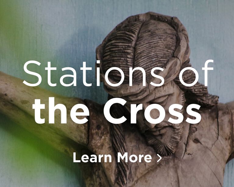 A close up image of the top of a statue of Jesus looking down while hanging on the cross. Image links to Stations of the Cross page.